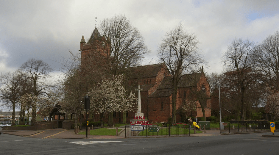 View of All Saints Church and War Memorial 2016. Trees in front.
